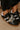The Kimber Faux Leather Charm Sneakers in Black   
